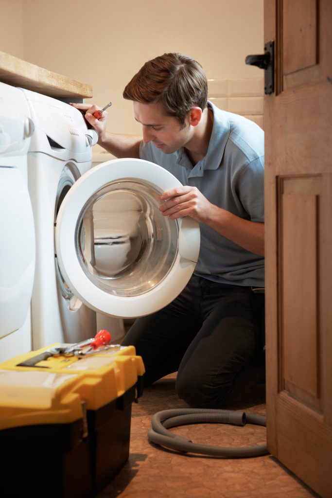 Engineer Mending Domestic Washing Machine Buckley Heating & Cooling